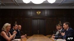 Russian parliament speaker Sergei Naryshkin (front right) meets with France's National Front leader Marine Le Pen (left) in Moscow last week. Analysts say the Kremlin and France's far-right share a similar ideological model based on an aggressive anti-U.S, Euroskeptic attitude. 