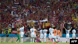 Costa Rica's players celebrate with the fans after a Group D football match between