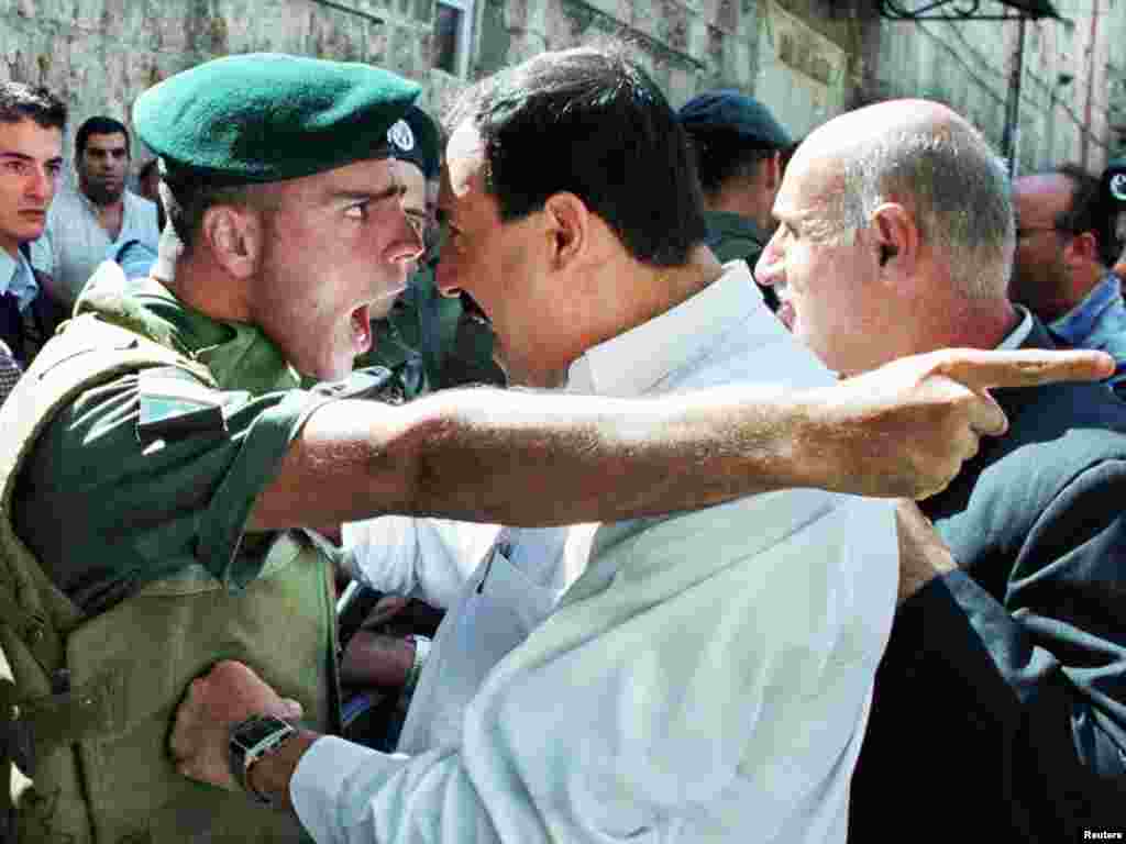 An Israeli Border Policeman and a Palestinian scream at each other face to face in the Old City of Jerusalem October 13, 2000 as the Palestinian is refused entry to the al-Aqsa mosque for Friday prayers. Israeli security forces prevented thousands of Palestinians from attending Friday prayers over concern for continued unrest and clashes following the prayers due to the increased tensions and fighting in the West Bank and Gaza Strip. REUTERS/Amit Shabi 