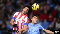 Spain -- Atletico Madrid's Arda Turan (L) vies with Celta's defender Hugo Mallo (R) during the Spanish League football match Atletico de Madrid vs Celta de Vigo at Vicente Calderon stadium in Madrid, 21Dec2012