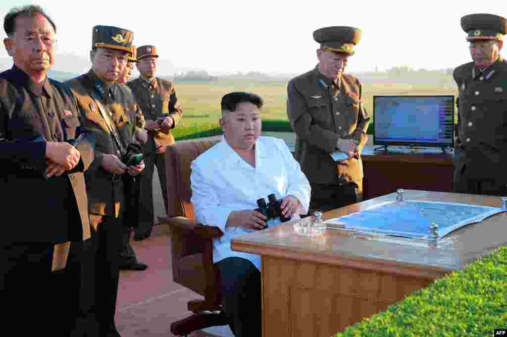 This undated picture released by North Korea's official Korean Central News Agency on May 28 shows North Korean leader Kim Jong Un (center) inspecting the test of a new antiaircraft weapons system at an undisclosed location. The North has carried out two atomic tests and dozens of ballistic-missile launches over the past year and a half. The nuclear program and missile tests have been banned by the UN, but Pyongyang has said they are necessary to counter U.S. aggression.