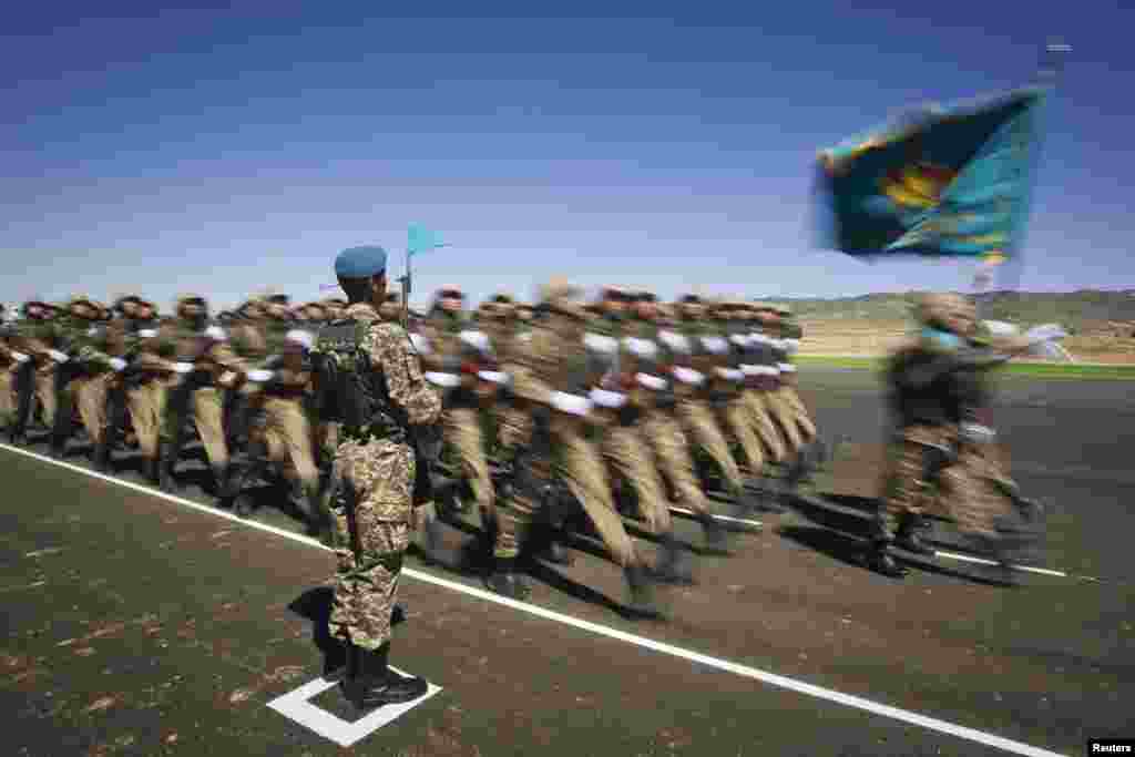 Kazakh troops march during a military parade on Fatherland Defenders' Day at the Otar military range, some 150 kilometers west of Almaty. (AFP/Behrouz Mehri)