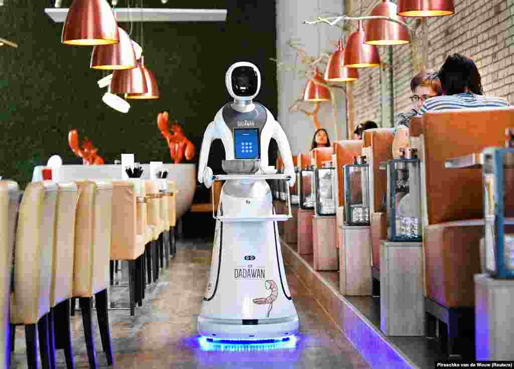 A robot serves customers in a Chinese restaurant in Maastricht, Netherlands. The robot was purchased “to reduce the risk of spreading the coronavirus disease,” according to Reuters.