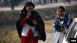 Distraught parents whose children are trapped in the school arrive close to the school following an attack at the Army run school in Peshawar on December 16.