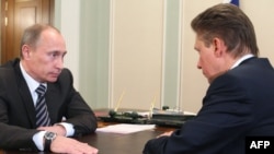 Russian Prime Minister Vladimir Putin (left) meets with Gazprom chief Aleksei Miller.