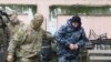 UKRAINE -- A member of Russia's FSB security service escorts a detained Ukrainian navy sailor (R) before a court hearing in Simferopol, Crimea, November 27, 2018