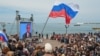 Crimean residents watch a TV broadcast with Russian President Vladimir Putin after the peninsula was annexed by Moscow earlier this year. 