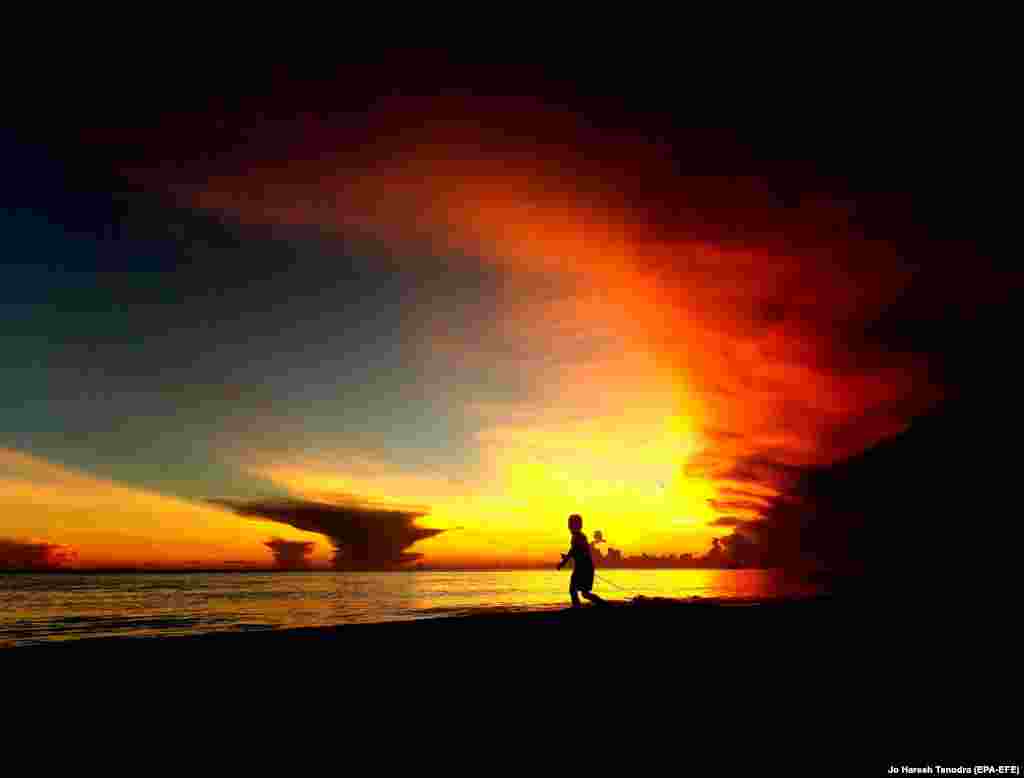 A Filipino villager boy plays as the sun sets on the resort island of Boracay on May 25. (epa-EFE/Jo Haresh Tanodra)