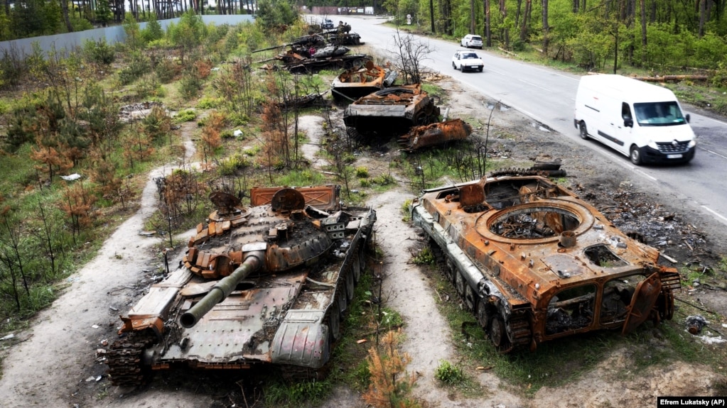 Cars pass by destroyed Russian armored vehicles outside Kyiv late last month. Although the Kremlin has failed in its initial bid to take his country's capital, Ukrainian lawmaker and special forces commander Roman Kostenko believes Moscow hasn't abandoned its ambitions to take the city. 