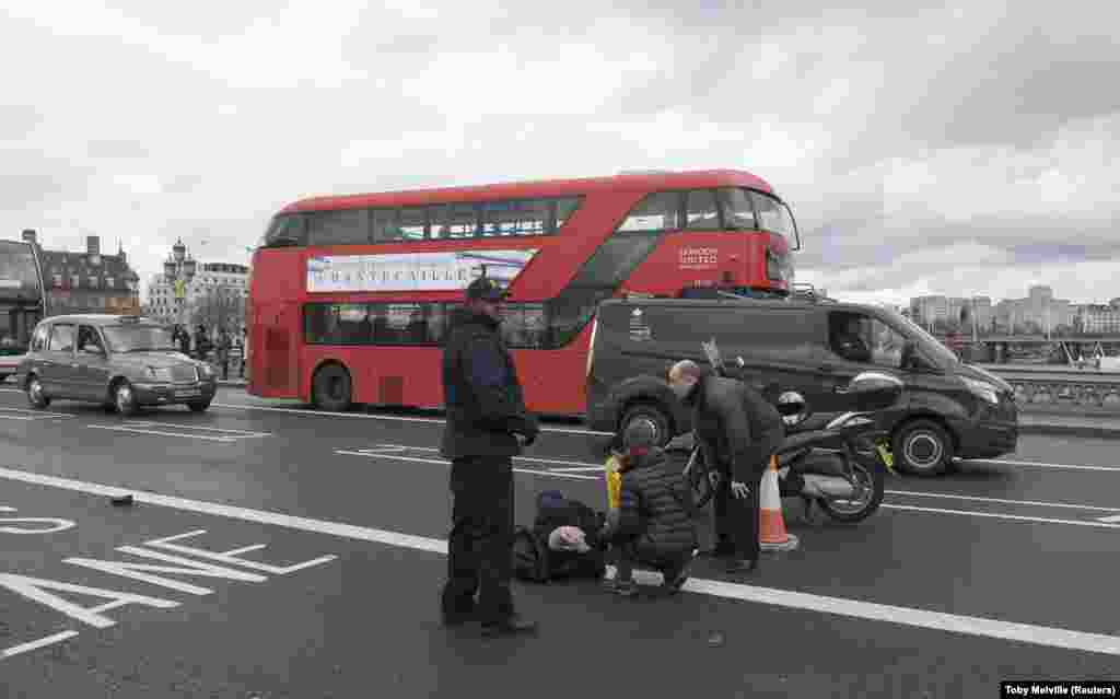 A man lies injured on Westminster Bridge.