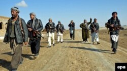 Члены подразделения афганской местной полиции, также известной как «Арбаки», патрулируют в районе Калы-Зал в провинции Кундуз.