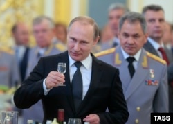 Russian President Vladimir Putin (foreground) and Defense Minister Sergei Shoigu. Russia has sought to move away from relying on Western technology for its newest military weaponry. It’s also kept up secretive efforts to acquire that technology without attracting attention.