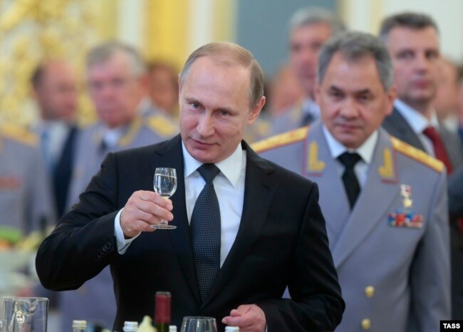 Russian President Vladimir Putin (foreground) and Defense Minister Sergei Shoigu. Russia has sought to move away from relying on Western technology for its newest military weaponry. It’s also kept up secretive efforts to acquire that technology without attracting attention.