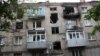 <p>An apartment building damaged by shelling.</p>
