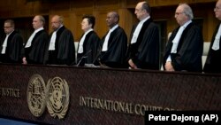 Judges enter the International Court of Justice, or World Court, in The Hague, October 3, 2018