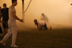 Protesters amidst smoke from flash-bang grenades during the clashes on election night.