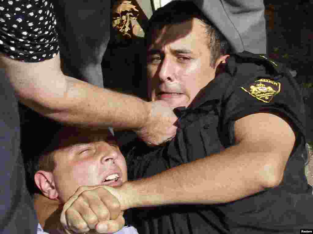 A policeman detains an opposition activist during a rally in Tbilisi on August 19. Dozens of street vendors and opposition supporters gathered in Georgia's capital to protest against the government's decision to ban street markets. Photo by David Mdzinarishvili for Reuters