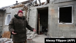 Артиллериялық шабуылдан қираған үйінің алдында тұрған әйел. Авдеевка ауылы, Донецк облысы, Украина. 2 ақпан 2017 жыл.