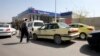 Syrians queue to fill their cars with gasoline at a station in the capital Damascus on April 8, 2019. 