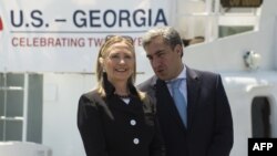 Georgia -- Prime Minister Nika Gilauri (R) and US Secretary of State Hillary Clinton speak during a Coast Guard ship commissioning ceremony at the passenger terminal wharf in Batumi, 05Jun2012