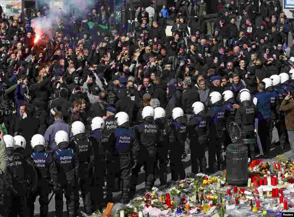 Right-wing demonstrators confront police in front of the old stock exchange in Brussels following deadly bombings in the Belgian capital that killed dozens of people. (Reuters/Yves Herman)