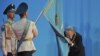 No kiss goodbye: Kazakh President Nursultan Nazarbaev kisses the national flag during his inauguration ceremony for a fourth term in Astana on April 8.