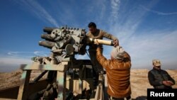 Iraqi Army personnel reload ammunition during clashes with Islamic State militants north of Mosul on December 29. 