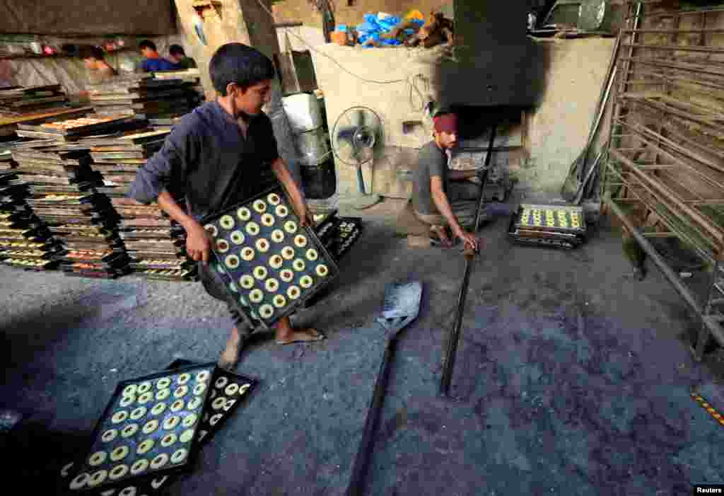 Afghan men make sweets at a traditional factory in Jalalabad. (Reuters/Parwiz)