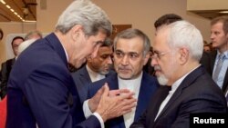 US Secretary of State John Kerry (L) speaks with Hossein Fereydoun (C), the brother of Iranian President, and Iranian Foreign Minister Javad Zarif (R), before a press conference in Vienna, July 14, 2015