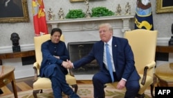 US President Donald Trump shakes hands with Pakistani Prime Minister Imran Khan (L) during a meeting in the Oval Office at the White House in Washington, DC, on July 22, 2019.