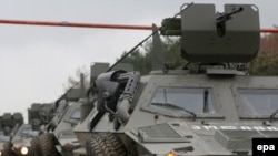 Armored vehicles leave the Mukhrovani army base after putting down the mutiny in May