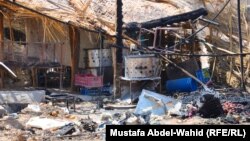 آثار التفجير الذي إستهدف سوقاً شعبية في كربلاء (الأحد)