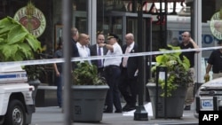 Police stand near the covered body of the suspected shooter on 5th Avenue near the Empire State Building in New York City on August 24.