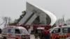 Ambulances and fire brigade arrive near the site of a plane crash in Islamabad on March 11.