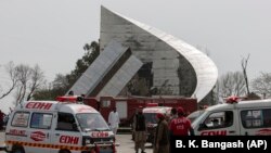 Ambulances and fire brigade arrive near the site of a plane crash in Islamabad on March 11.