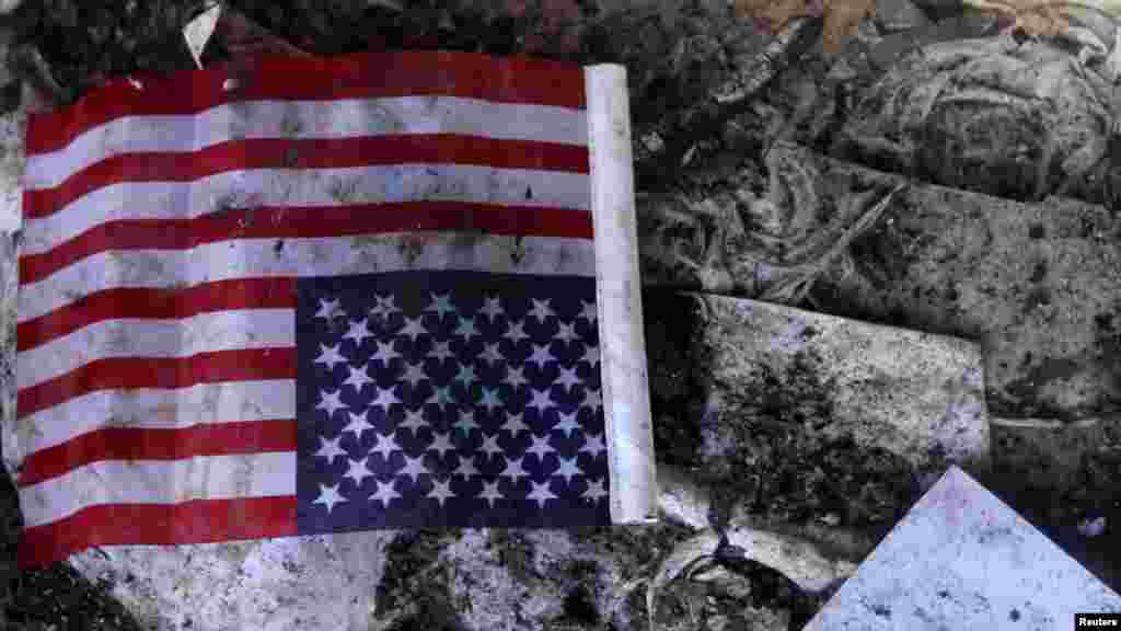 A U.S. flag is seen at the U.S. consulate in Benghazi, Libya, on September 12, a day after the consulate was attacked by gunmen and set on fire. Christopher Stevens, the U.S. ambassador to Libya, and three embassy staff were killed in the attack as they tried to flee. (Reuters/Esam Al-Fetori)
