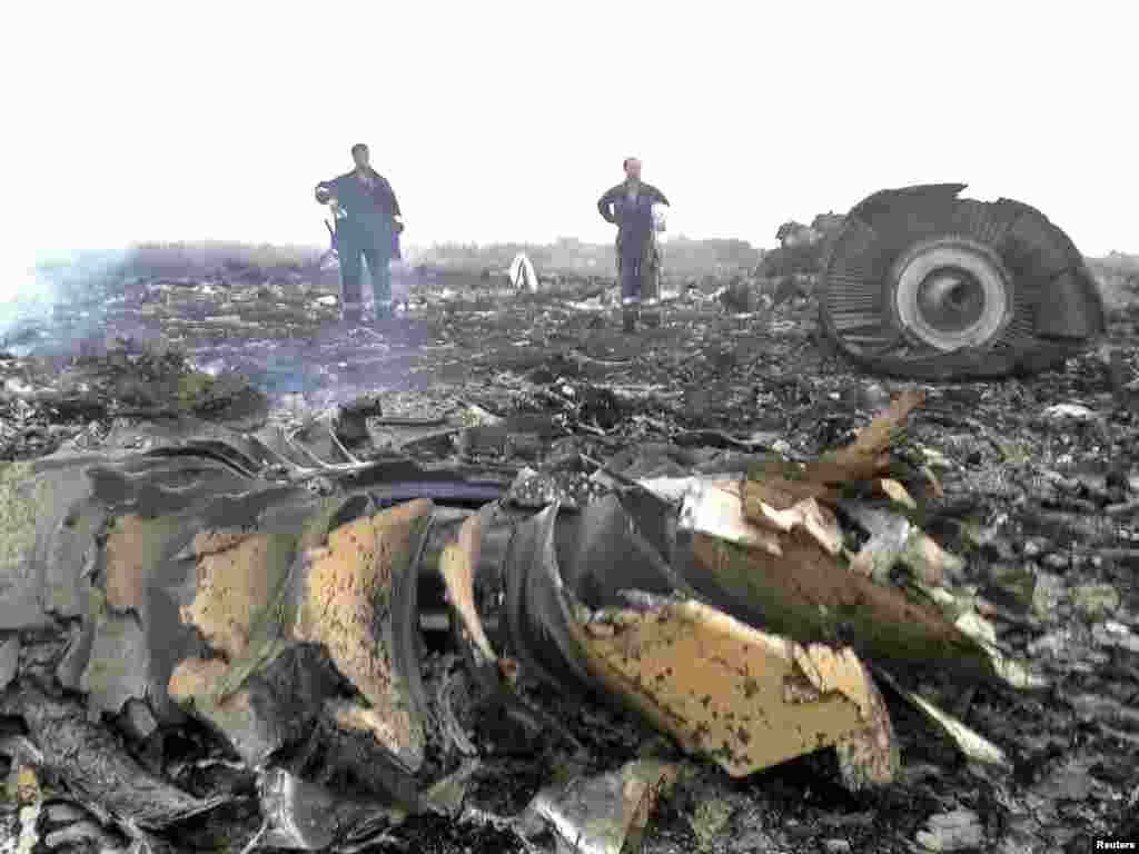 Emergency service workers survey the crash site.