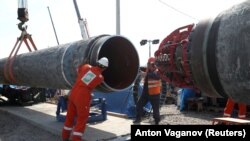 Workers are seen at the construction site of the Nord Stream 2 gas pipeline near the town of Kingisepp in Russia's Leningrad region in June.