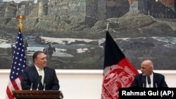 Afghan President Ashraf Ghani (R) speaks during a press conference with U.S. Secretary of State Mike Pompeo, at the presidential palace in Kabul on July 9.