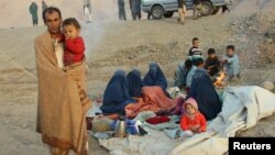 An Afghan family waits for help from the government and aid organizations in the northern Takhar province after fleeing their homes in neighboring Kunduz province in October.