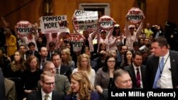 Code Pink protesters yell behind CIA Director Mike Pompeo as he waits to testify before a Senate Foreign Relations Committee confirmation hearing on Pompeo's nomination to be secretary of state on Capitol Hill in Washington, April 12, 2018. FILE PHOTO
