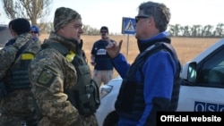 Ukrainian soldiers talk with monitors of the OSCE Special Monitoring Mission in Donbas in October 2015.