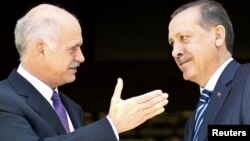 Greek Prime Minister George Papandreou (left) greets his Turkish counterpart Recep Tayyip Erdogan in Athens.