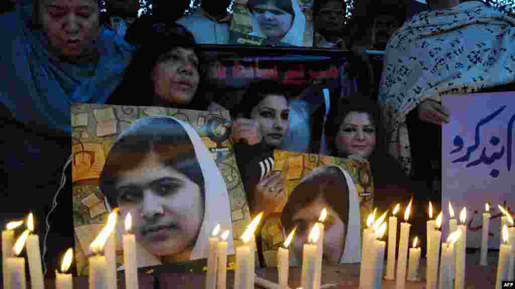 Supporters hold photographs of 15-year-old Pakistani activist Malala Yousafzai, who was shot in the head by the Taliban in October, during commemorations marking Human Rights Day in Lahore. Malala's father has been named a UN special adviser on global education. Malala is recovering in a British hospital. (AFP/Arif Ali)