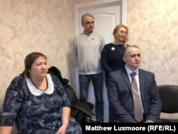 Konstantin Vyatkin (right) and other U.S.S.R. revivalists listen to YouTube star Valentina Reunova at a meeting in Moscow in April.