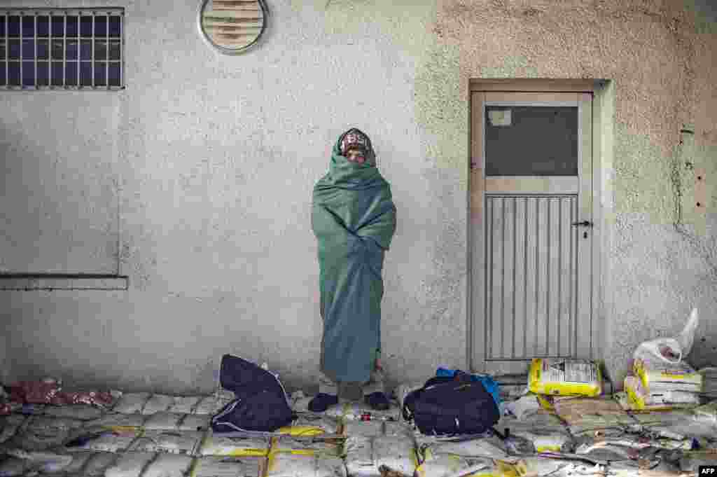 A man wrapped in a blanket waits with other migrants and refugees to cross the Slovenian-Austrian border in Sentilj, Slovenia. (AFP/Rene Gomolj)