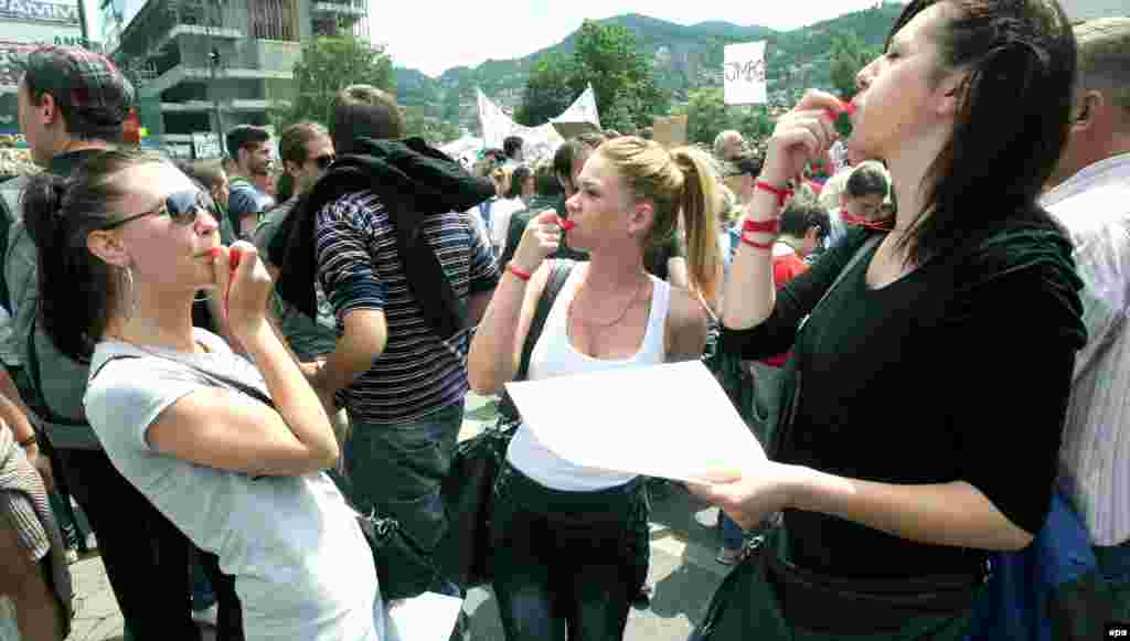 People blowing whistles at the demonstration on June 11.