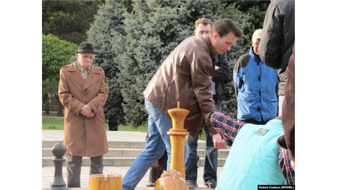 Men play chess in Chisinau's Cathedral Park on April 18.