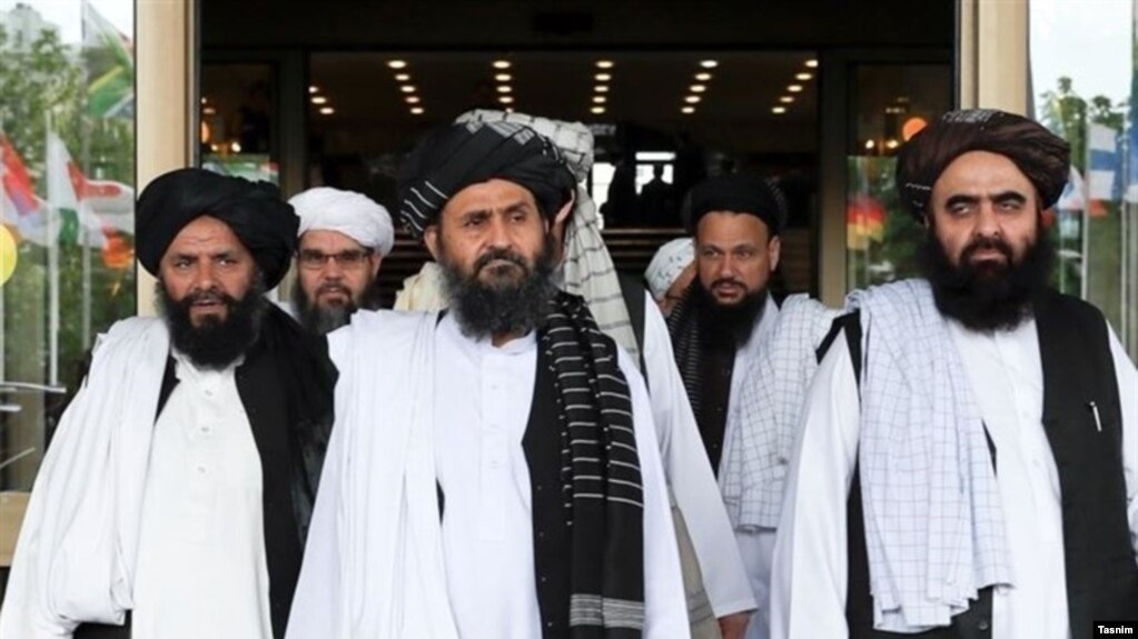 FILE: Taliban deputy leader Mullah Abdul Ghani Baradar (C) with members of the Taliban political office in Qatar.