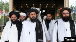 FILE: Taliban deputy leader Mullah Abdul Ghani Baradar (C) with members of the Taliban political office in Qatar.